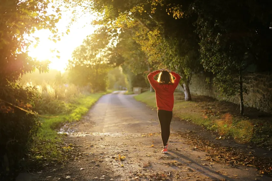 Woman in her 50s walking briskly outdoors on a sunny path
