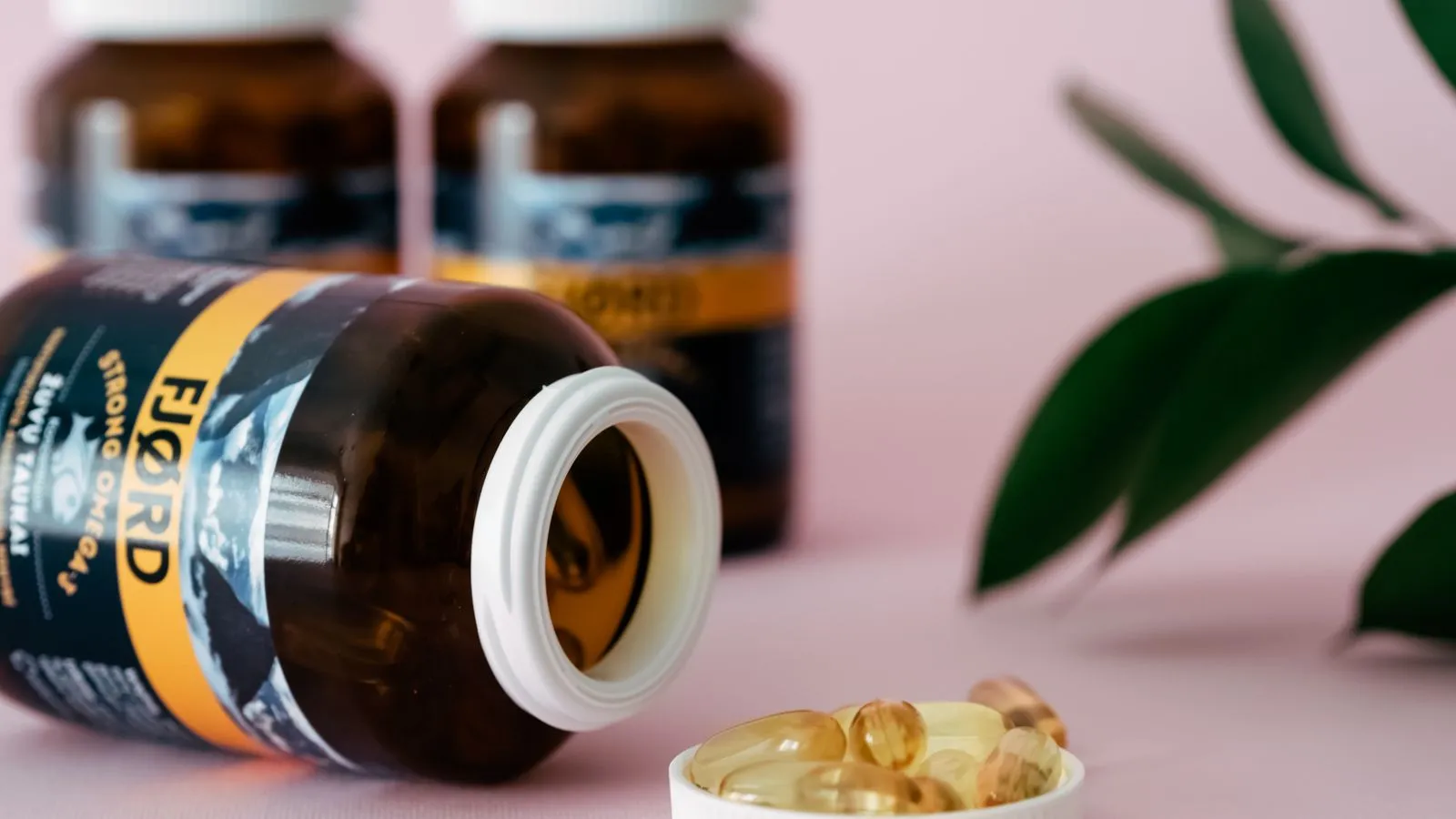 Dietary supplement bottles on a neutral background